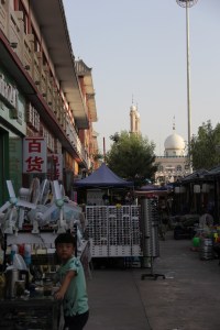Mosque parapets rise above on of Dunhuang's markets.