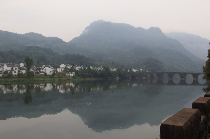 Mount Qiyun is wreathed in clouds above a Huizhou village.