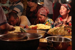 Locals gather around a noodle stand.