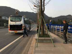 We wait roadside next to our broken-down bus for something to change.