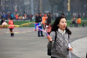 A woman blows a long bubble on Tianfu Square.