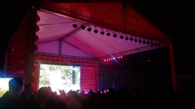 A crowd gathers around a public showing of the annual New Year's gala.